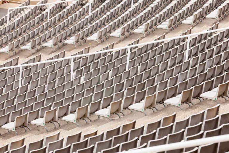 Rows of seats at empty tribunes of the large stadium